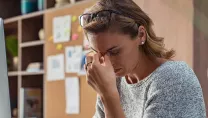 Business woman with headache in office