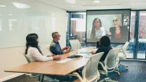 Business people having a virtual meeting in a boardroom