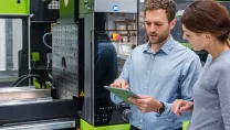 Colleagues controlling machinery with a tablet