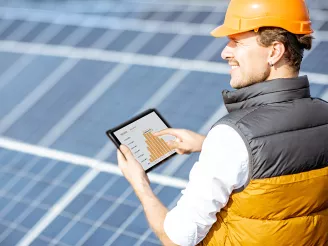 Man holding a tablet showing PV flash data chart