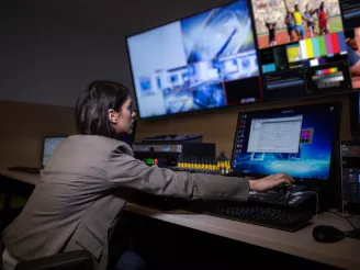 woman looking at multiple displays 8K-Audio Visual-Product