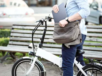 A man putting a laptop into his bag