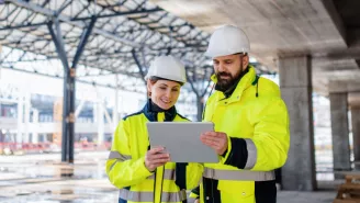 Engineers using a tablet on a construction site