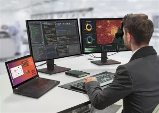 windows-computers-for-in-office-workers-man working on a dual screen with laptop