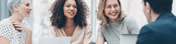 Four people laughing and talking