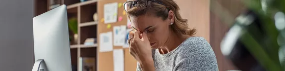 Business woman with headache in office