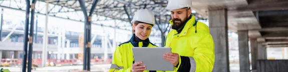 Engineers using a tablet on a construction site