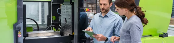 Colleagues controlling machinery with a tablet