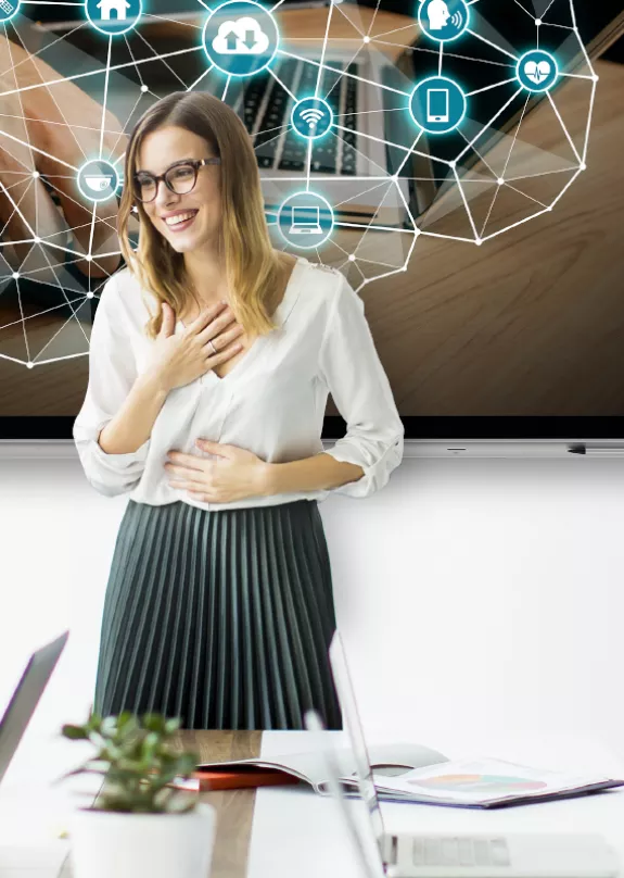 Office workers clapping in meeting room with a presentation on screen and a printer at the side