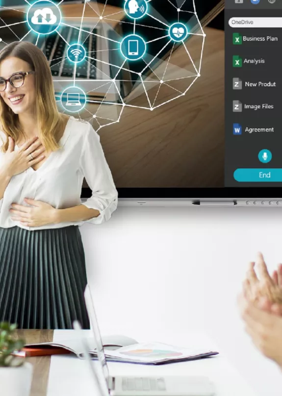 Office workers clapping in meeting room with a presentation on screen and a printer at the side