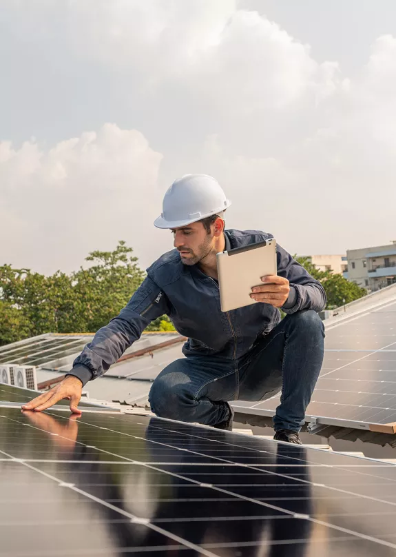 Technician checking commercial roof with solar panel installation