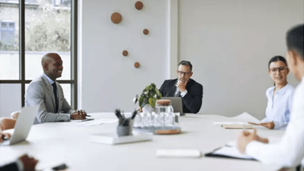 meeting room, staff around a table having a meeting about cyber security training